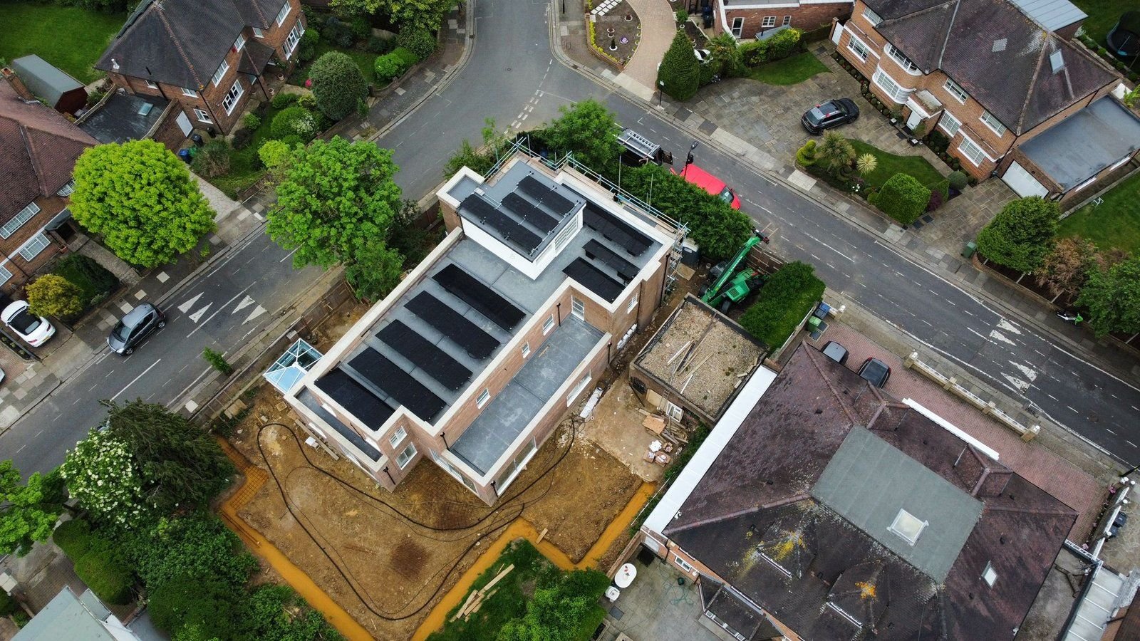 Aerial view of the completed installation, with solar panels mounted at 13 degrees across the flat roof